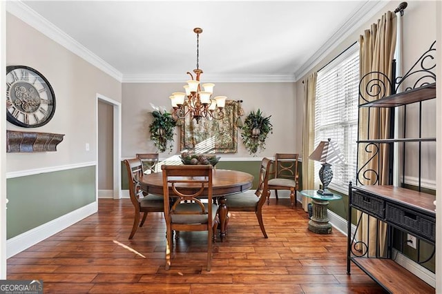 1070 Cureton Dr, Austell, GA 30106 - dining area featuring a chandelier, crown molding, and wood finished floors