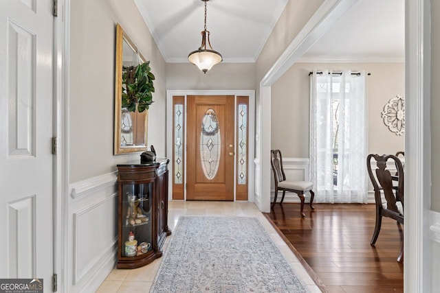 595 S Antioch Rd, Mcdonough, GA 30252 - entrance foyer featuring a wainscoted wall, crown molding, a decorative wall, and light wood-style floors