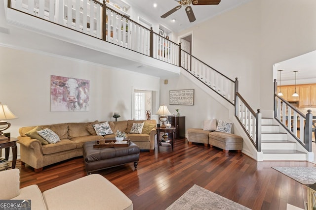 595 S Antioch Rd, Mcdonough, GA 30252 - living room featuring a towering ceiling, a ceiling fan, hardwood / wood-style flooring, stairway, and crown molding