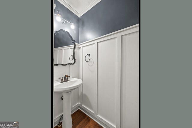 220 Drumcliff Ct, Tyrone, GA 30290 - bathroom with a decorative wall, ornamental molding, wood finished floors, a wainscoted wall, and a sink