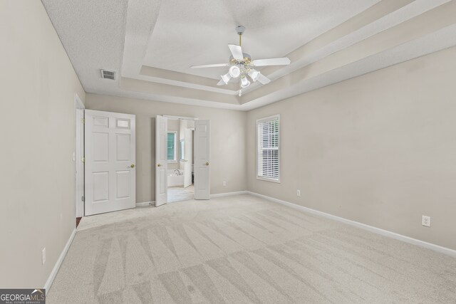 220 Drumcliff Ct, Tyrone, GA 30290 - unfurnished bedroom featuring light carpet, a raised ceiling, baseboards, and connected bathroom