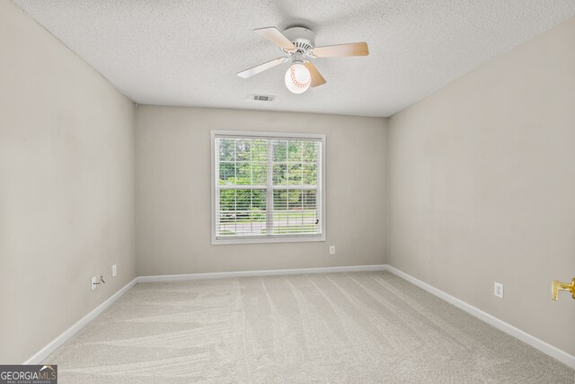 220 Drumcliff Ct, Tyrone, GA 30290 - empty room featuring a textured ceiling, light colored carpet, ceiling fan, and baseboards