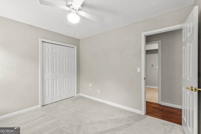 220 Drumcliff Ct, Tyrone, GA 30290 - unfurnished bedroom featuring carpet, a closet, baseboards, and a textured ceiling