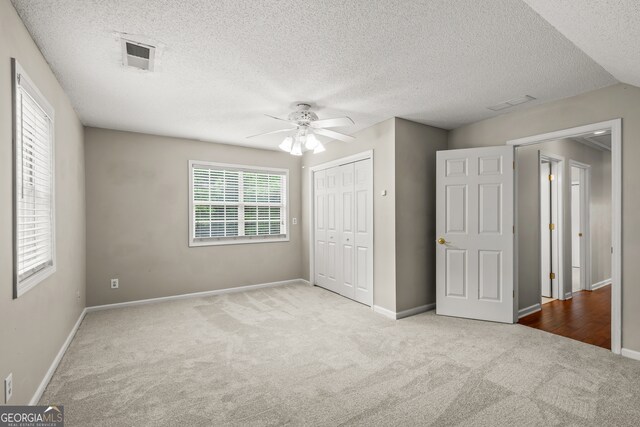 220 Drumcliff Ct, Tyrone, GA 30290 - unfurnished bedroom with carpet, a closet, baseboards, a textured ceiling, and a ceiling fan