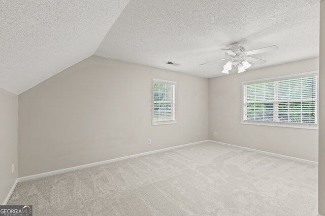 220 Drumcliff Ct, Tyrone, GA 30290 - additional living space with a textured ceiling, light colored carpet, ceiling fan, healthy amount of natural light, and baseboards