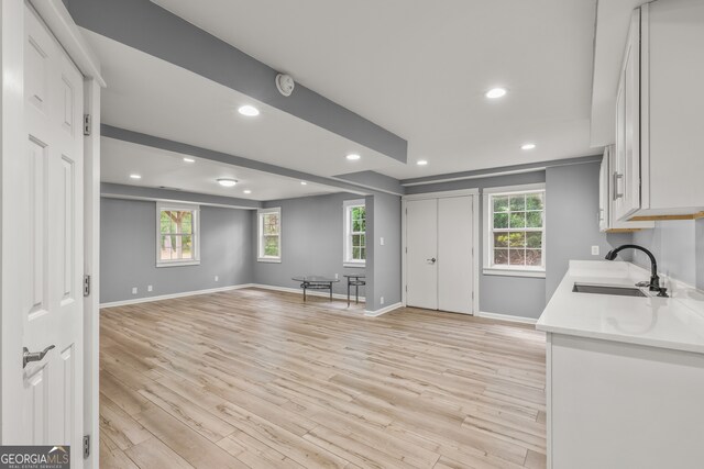 220 Drumcliff Ct, Tyrone, GA 30290 - kitchen featuring a sink, light countertops, light wood-style flooring, baseboards, and recessed lighting