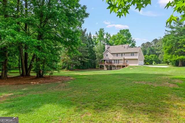 220 Drumcliff Ct, Tyrone, GA 30290 - view of green lawn with an attached garage, a deck, and driveway