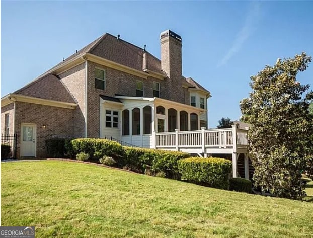 6529 Terraglen Way, Locust Grove, GA 30248 - back of house with a chimney, a yard, a deck, and brick siding