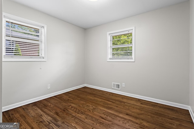 624 Lyle Dr SE, Marietta, GA 30067 - spare room with baseboards and dark wood-type flooring