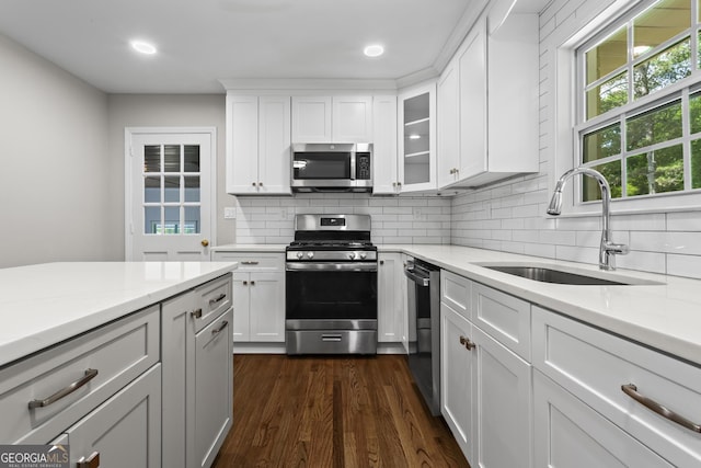 624 Lyle Dr SE, Marietta, GA 30067 - kitchen with appliances with stainless steel finishes, a sink, tasteful backsplash, dark wood-type flooring, and recessed lighting