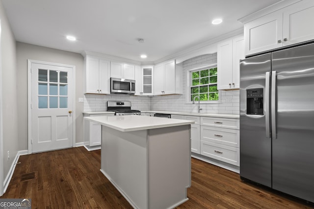 624 Lyle Dr SE, Marietta, GA 30067 - kitchen featuring appliances with stainless steel finishes, white cabinetry, decorative backsplash, a kitchen island, and recessed lighting