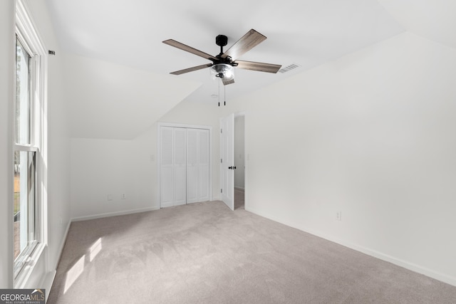 9 Wimbledon Ct, Statesboro, GA 30458 - empty room with plenty of natural light, carpet flooring, ceiling fan, baseboards, and lofted ceiling