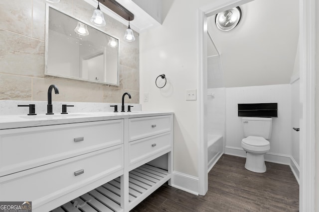 9 Wimbledon Ct, Statesboro, GA 30458 - bathroom with double vanity, toilet, wood finished floors,  shower combination, and baseboards