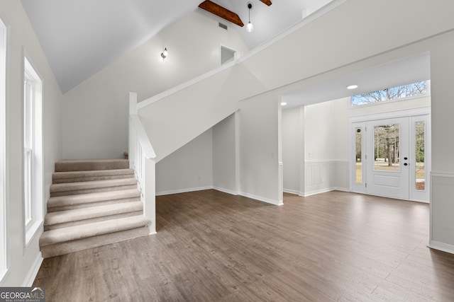 9 Wimbledon Ct, Statesboro, GA 30458 - unfurnished living room with wood finished floors, stairway, high vaulted ceiling, and beamed ceiling