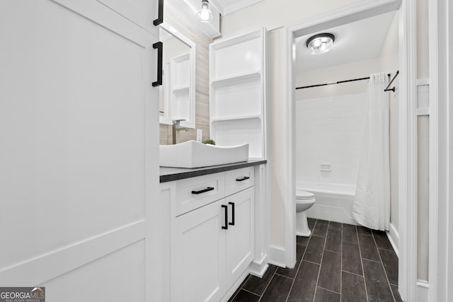 9 Wimbledon Ct, Statesboro, GA 30458 - full bathroom featuring toilet, vanity, shower / bath combo with shower curtain, and wood tiled floors