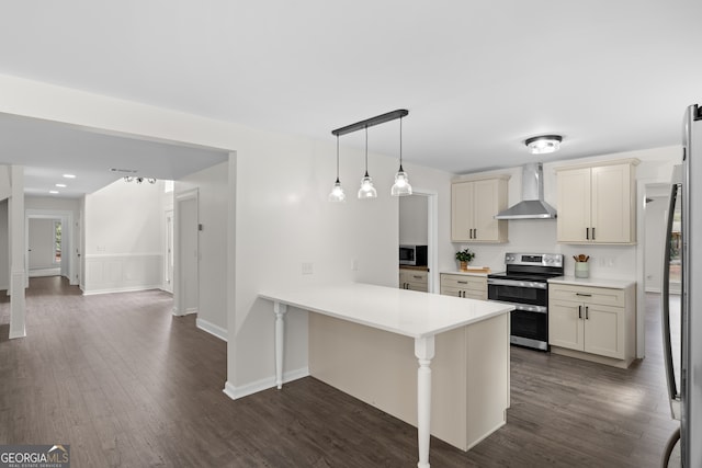 9 Wimbledon Ct, Statesboro, GA 30458 - kitchen featuring appliances with stainless steel finishes, wall chimney exhaust hood, a peninsula, dark wood-style floors, and light countertops