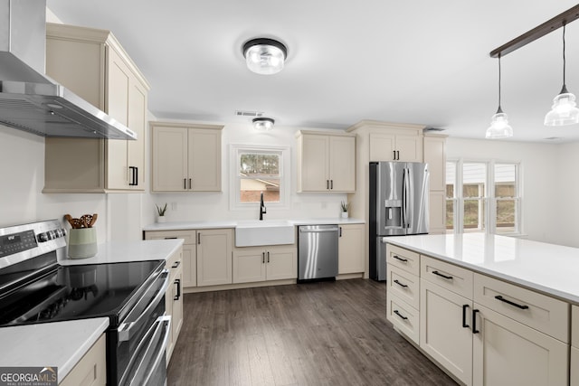 9 Wimbledon Ct, Statesboro, GA 30458 - kitchen with appliances with stainless steel finishes, wall chimney range hood, a sink, and cream cabinets