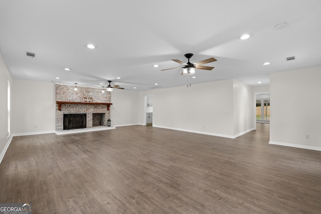 9 Wimbledon Ct, Statesboro, GA 30458 - unfurnished living room with ceiling fan, dark wood-style flooring, baseboards, a brick fireplace, and recessed lighting