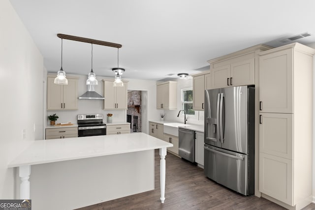 9 Wimbledon Ct, Statesboro, GA 30458 - kitchen featuring stainless steel appliances, a peninsula, wall chimney exhaust hood, a breakfast bar, and a sink