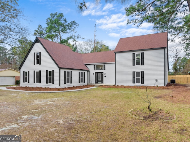 9 Wimbledon Ct, Statesboro, GA 30458 - view of front facade with a shingled roof, a front yard, an outbuilding, a detached garage, and cooling unit