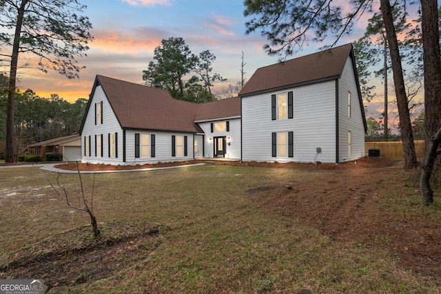 9 Wimbledon Ct, Statesboro, GA 30458 - rear view of property with roof with shingles, central air condition unit, a lawn, and a garage