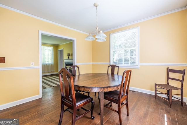 1268 Thomas Rd, Decatur, GA 30030 - dining area with baseboards, ornamental molding, a chandelier, and dark wood-style floors