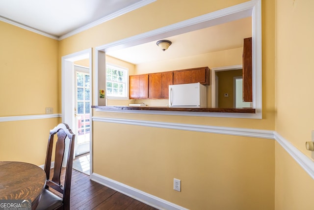 1268 Thomas Rd, Decatur, GA 30030 - kitchen featuring freestanding refrigerator, dark wood-type flooring, brown cabinetry, ornamental molding, and baseboards