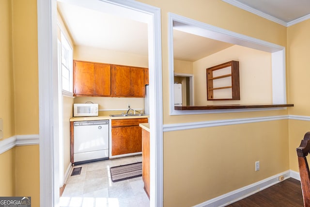 1268 Thomas Rd, Decatur, GA 30030 - kitchen with white appliances, a sink, brown cabinets, light countertops, and baseboards