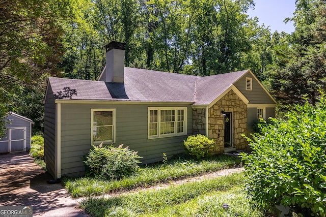 1268 Thomas Rd, Decatur, GA 30030 - view of front of property with a chimney, stone siding, and roof with shingles