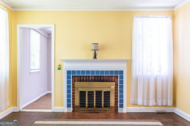 1268 Thomas Rd, Decatur, GA 30030 - detailed view of wood finished floors, a tiled fireplace, baseboards, and crown molding