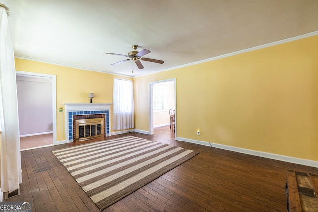 1268 Thomas Rd, Decatur, GA 30030 - unfurnished living room featuring a fireplace, crown molding, dark wood-style flooring, baseboards, and a ceiling fan