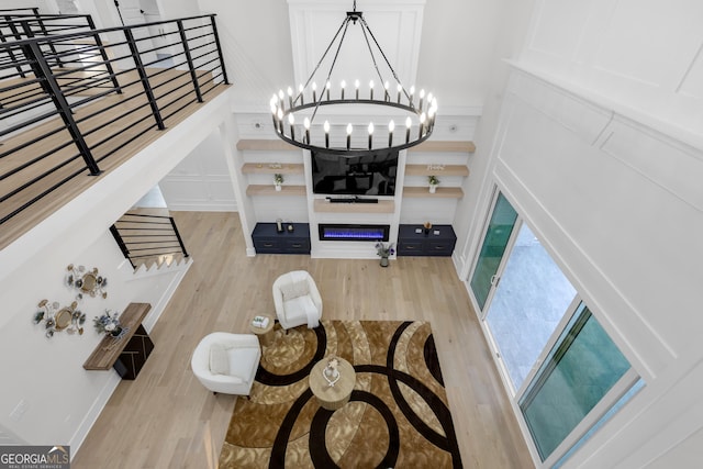 2631 Sardis Way, Buford, GA 30519 - living area with light wood-type flooring, a chandelier, and stairs