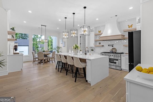 2631 Sardis Way, Buford, GA 30519 - kitchen with open shelves, high end range, freestanding refrigerator, custom exhaust hood, and white cabinetry