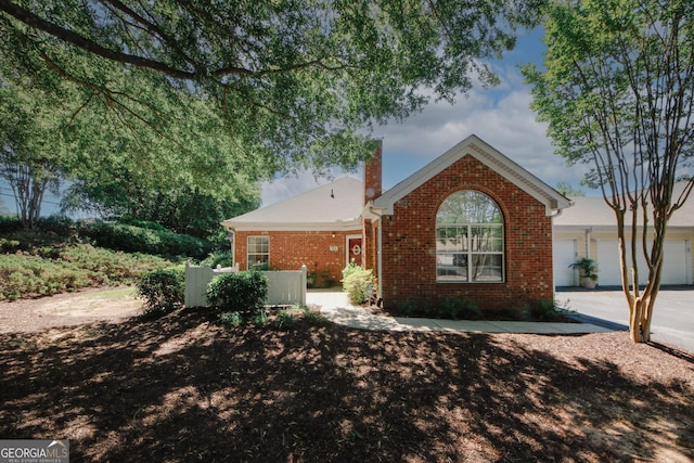 2191 Rockbridge Rd Unit 103, Stone Mountain, GA 30087 - ranch-style house with brick siding and a chimney