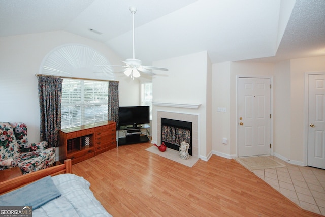 2191 Rockbridge Rd Unit 103, Stone Mountain, GA 30087 - living room featuring ceiling fan, a fireplace, vaulted ceiling, wood finished floors, and baseboards