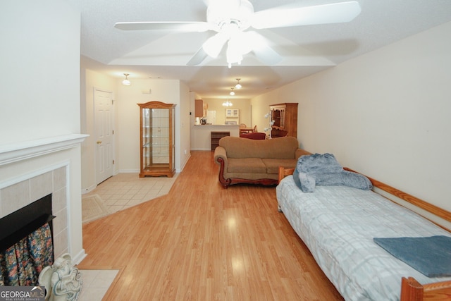 2191 Rockbridge Rd Unit 103, Stone Mountain, GA 30087 - bedroom featuring light wood-style floors, a fireplace, and a ceiling fan