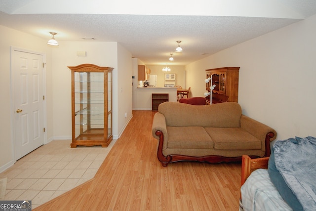 2191 Rockbridge Rd Unit 103, Stone Mountain, GA 30087 - living area with light wood-style floors, baseboards, and a textured ceiling