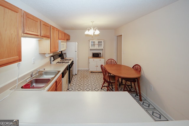 2191 Rockbridge Rd Unit 103, Stone Mountain, GA 30087 - kitchen with white appliances, a chandelier, light countertops, a sink, and pendant lighting