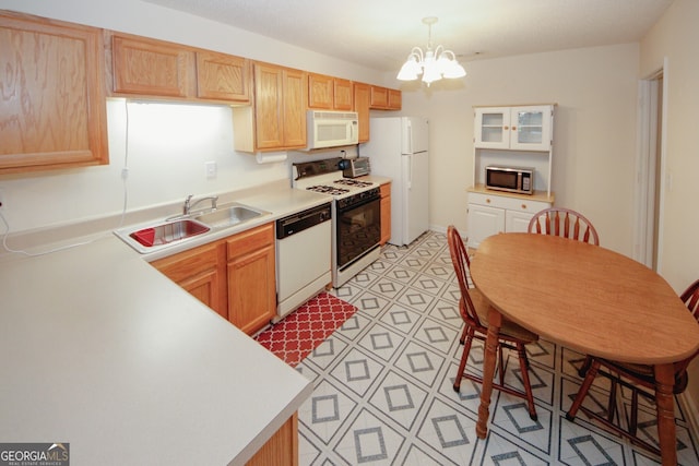 2191 Rockbridge Rd Unit 103, Stone Mountain, GA 30087 - kitchen featuring white appliances, a sink, light countertops, and a chandelier