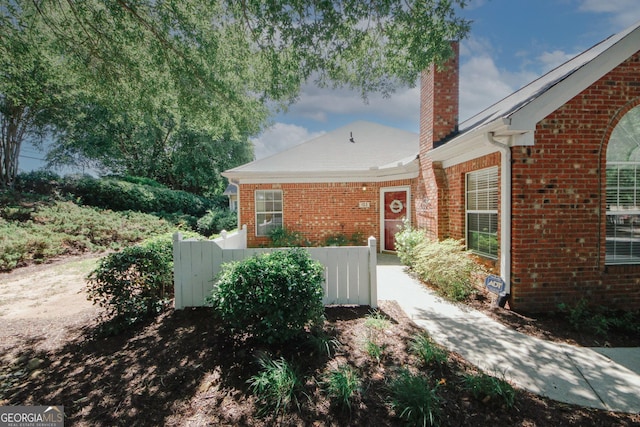 2191 Rockbridge Rd Unit 103, Stone Mountain, GA 30087 - view of home's exterior featuring a chimney and brick siding