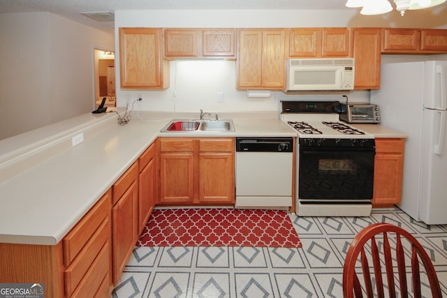 2191 Rockbridge Rd Unit 103, Stone Mountain, GA 30087 - kitchen with white appliances, a sink, light countertops, a peninsula, and light flooring