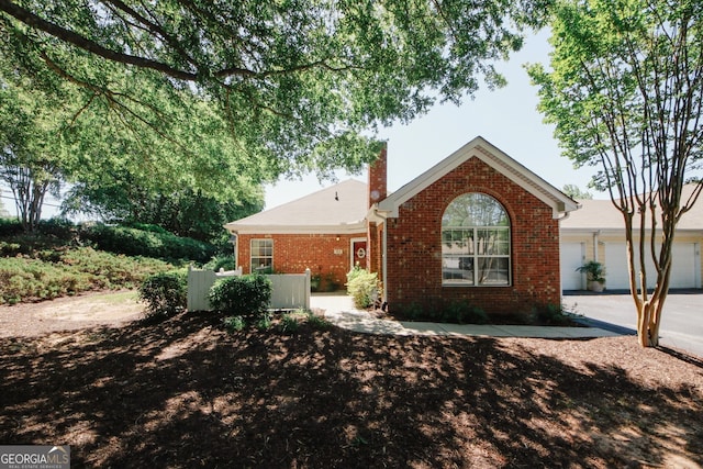2191 Rockbridge Rd Unit 103, Stone Mountain, GA 30087 - view of front facade featuring brick siding and a chimney