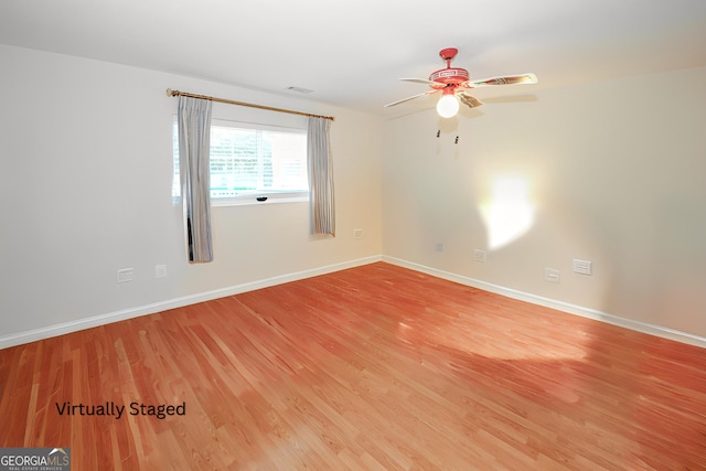 2191 Rockbridge Rd Unit 103, Stone Mountain, GA 30087 - empty room featuring light wood finished floors, a ceiling fan, and baseboards