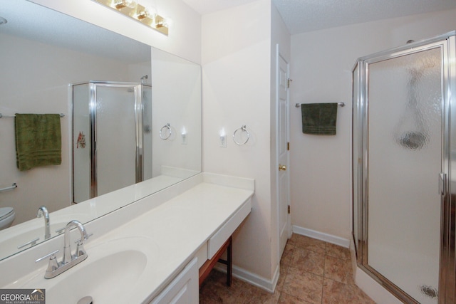 2191 Rockbridge Rd Unit 103, Stone Mountain, GA 30087 - bathroom featuring a shower stall, vanity, toilet, and baseboards