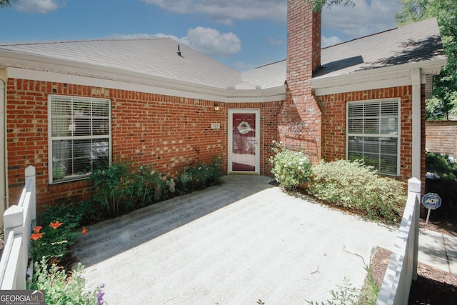 2191 Rockbridge Rd Unit 103, Stone Mountain, GA 30087 - entrance to property featuring brick siding, a chimney, and a patio area