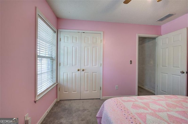 2908 Cottesford Way, Smyrna, GA 30080 - carpeted bedroom with multiple windows, baseboards, a closet, a ceiling fan, and a textured ceiling