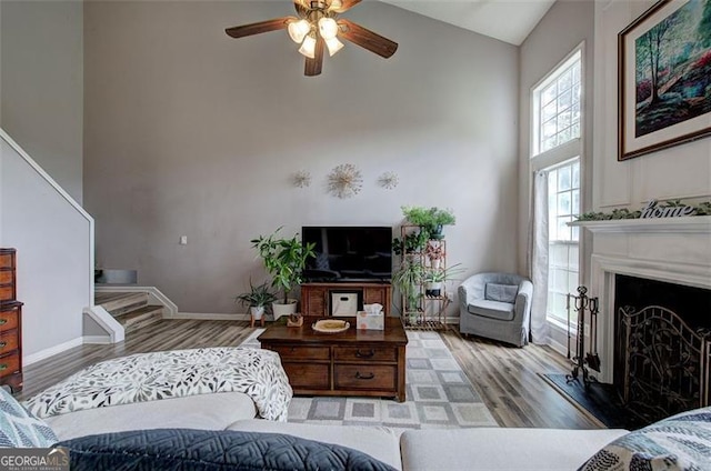 2908 Cottesford Way, Smyrna, GA 30080 - living area featuring high vaulted ceiling, wood finished floors, a ceiling fan, a fireplace with raised hearth, and baseboards