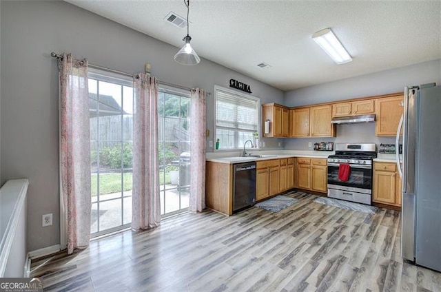 2908 Cottesford Way, Smyrna, GA 30080 - kitchen with stainless steel appliances, under cabinet range hood, light wood-type flooring, light countertops, and a sink