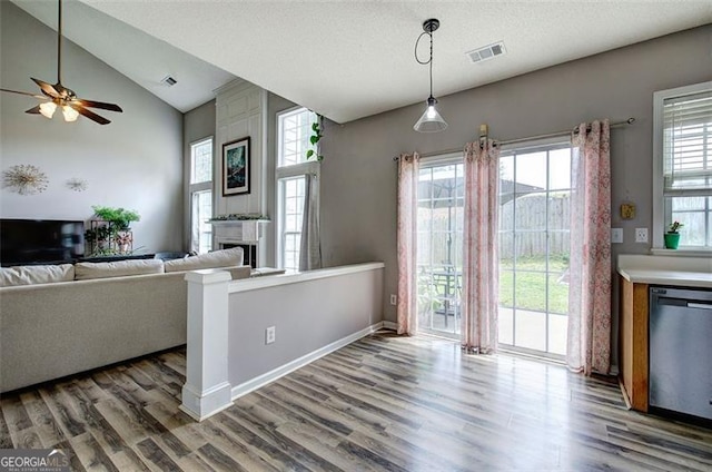 2908 Cottesford Way, Smyrna, GA 30080 - kitchen featuring dishwasher, a ceiling fan, wood finished floors, a fireplace, and vaulted ceiling
