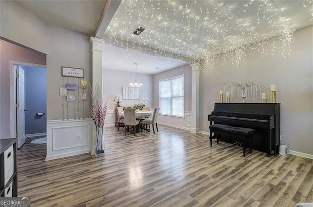 2908 Cottesford Way, Smyrna, GA 30080 - dining space featuring wood finished floors, a chandelier, baseboards, and ornate columns